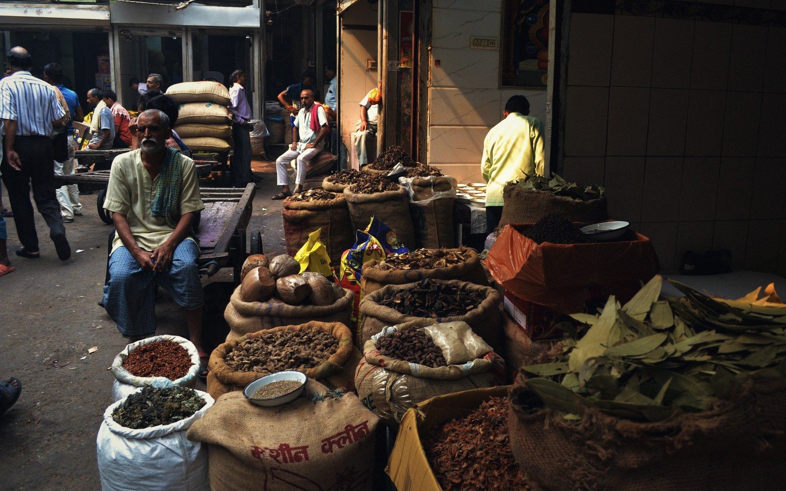 a market stall with produce stacked in the morning light